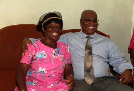 Birthday Girl Mrs. Millicent “Aunty Baby” Sutton and Premier of Nevis Hon. Joseph Parry share a light moment in celebration of her 80th birthday at her home in Cotton Ground Village